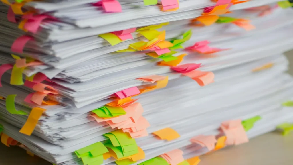 Stack of documents with colourful tabs for an employer GOSI registration