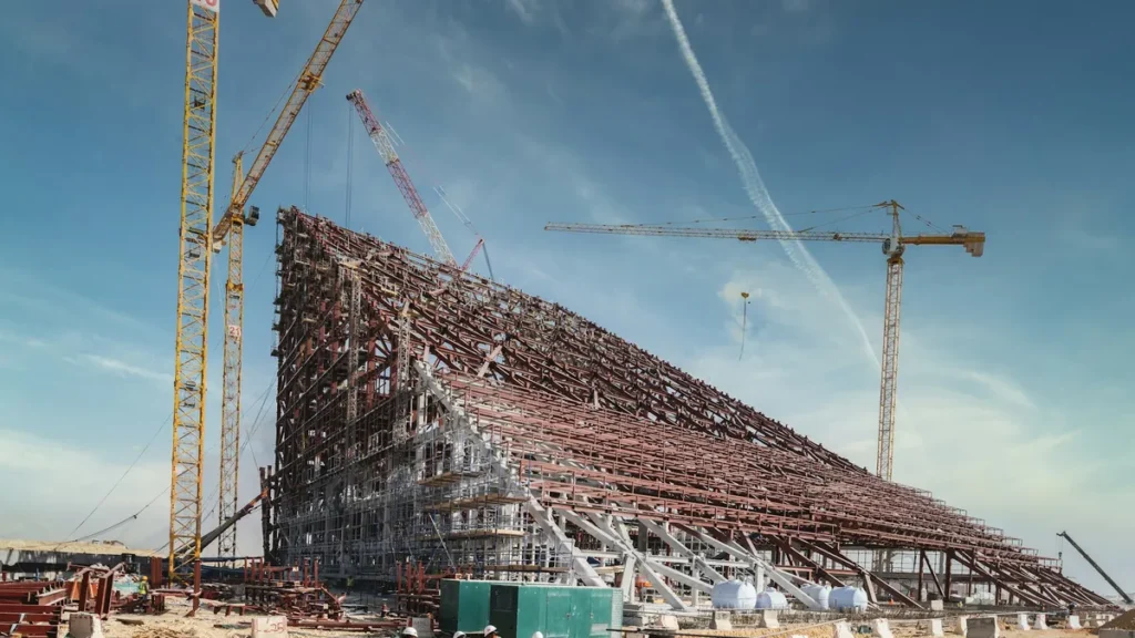 Construction site with cranes and a steel structure in Saudi Arabia, a sector with many expatriate workers
